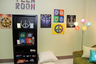 view of bookshelf and wall with posters