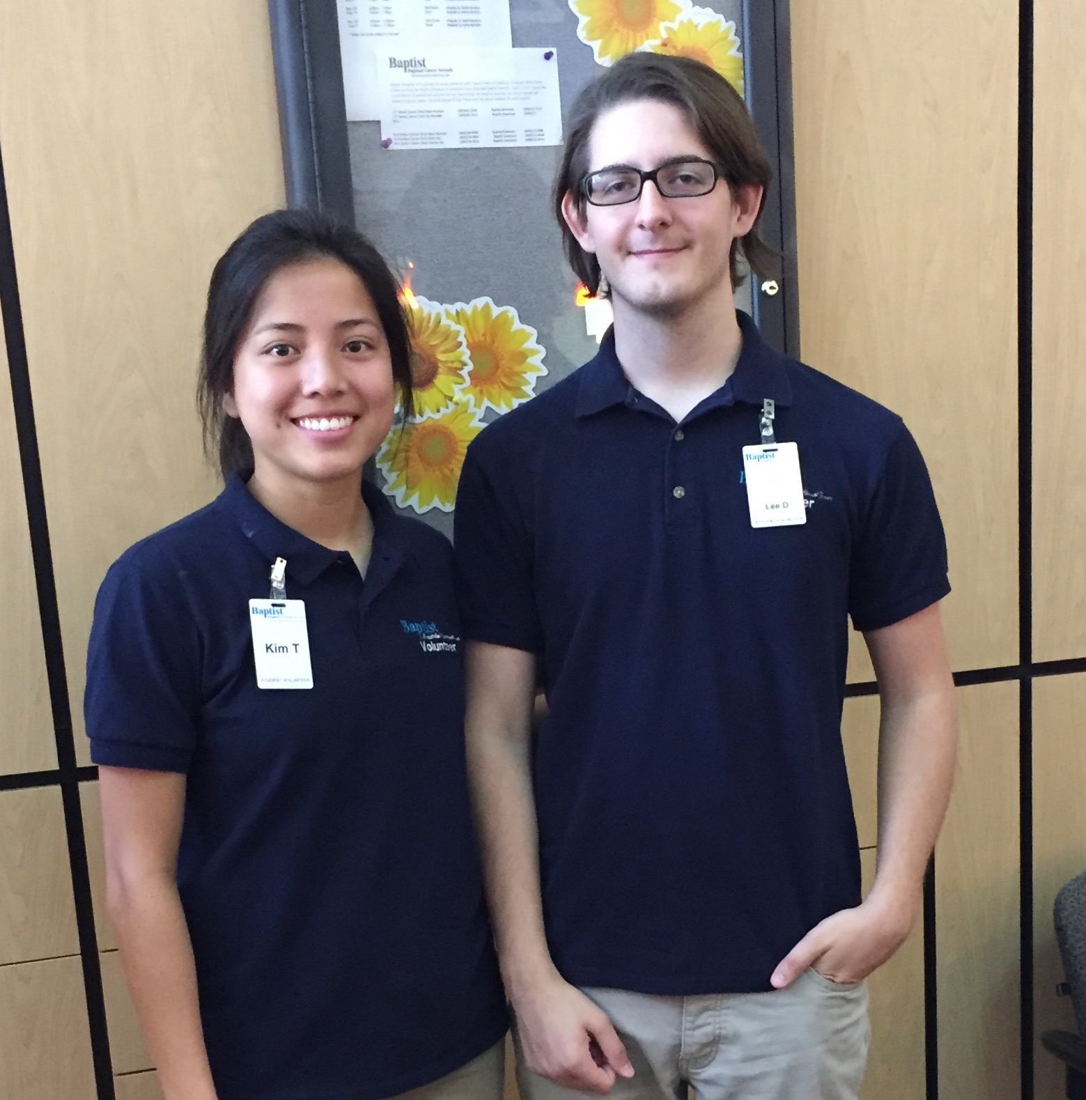 two volunteers standing together