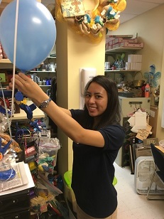 volunteer blowing up a balloon